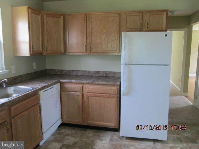 601 Crosby Road Baltimore, MD 21228 - Photo 7 of 16 a kitchen with stainless steel appliances granite countertop a refrigerator sink and cabinets