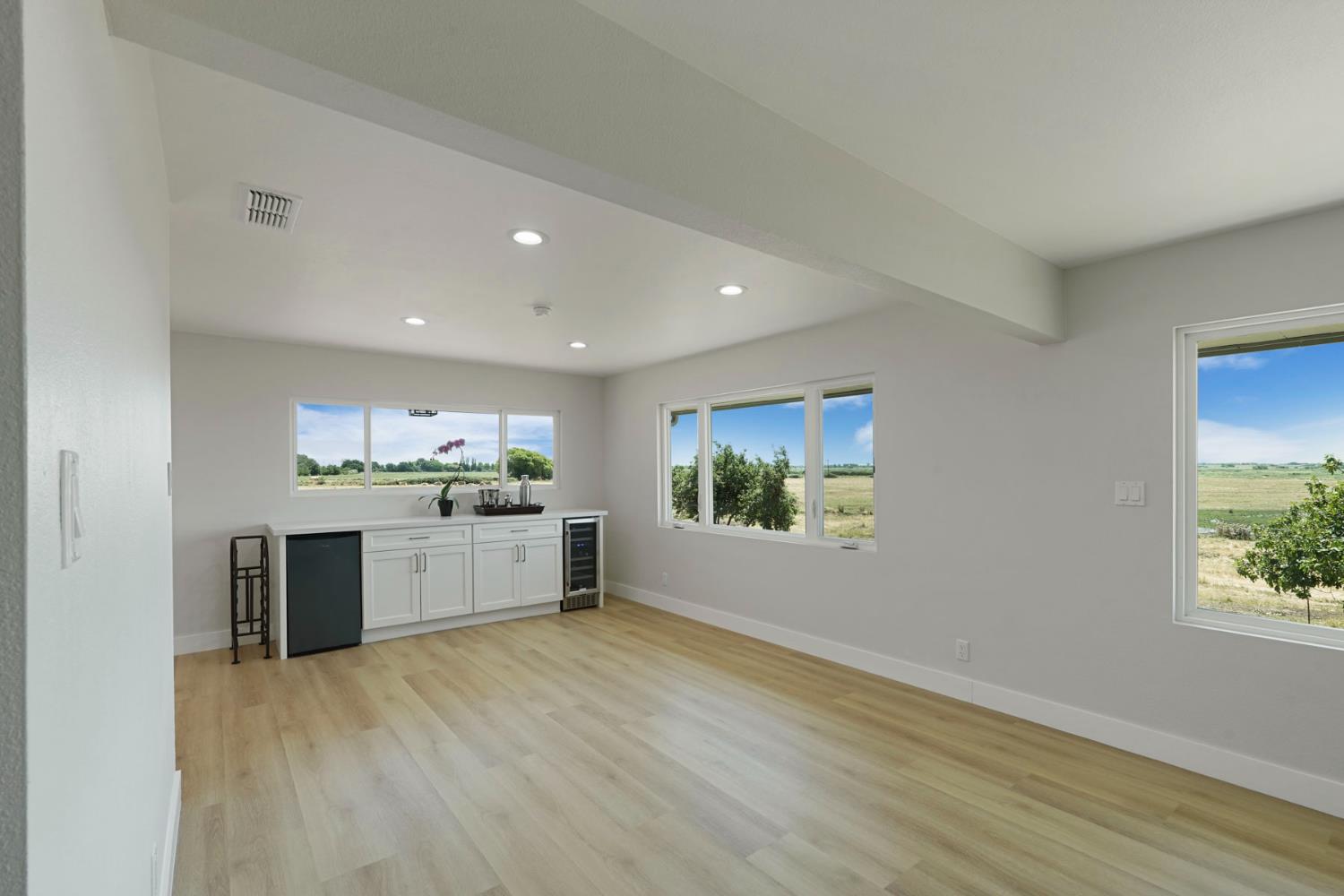 2650 West Twitchell Island Road Rio Vista, CA 94571 - Photo 39 of 60 a kitchen with stainless steel appliances kitchen island wooden floors and white cabinets