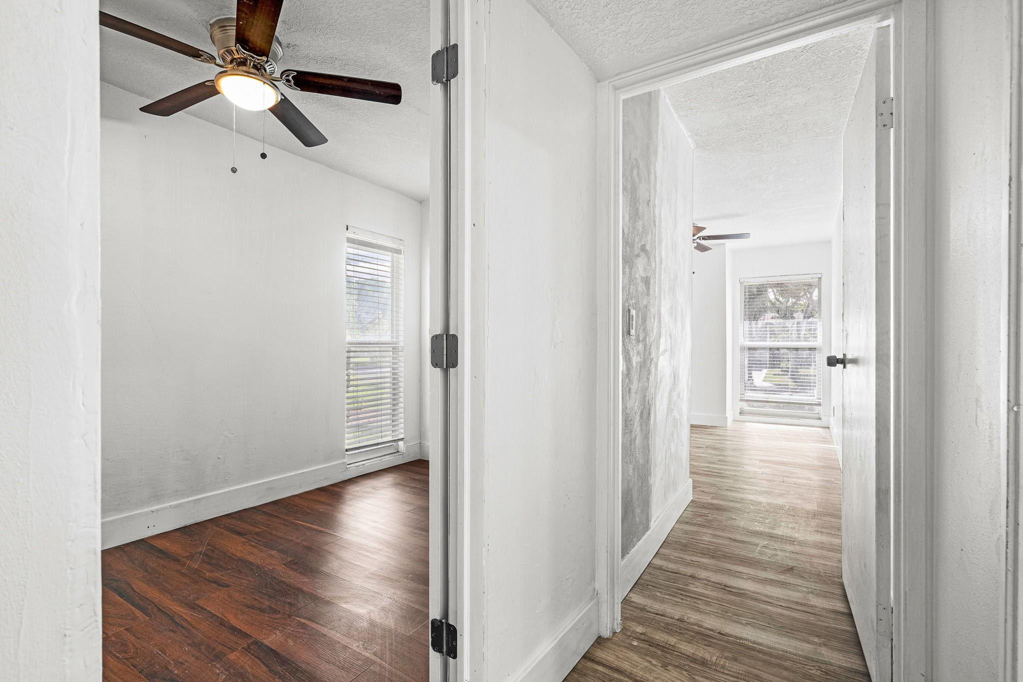 7007 Northwest 64th Street Tamarac, FL 33321 - Photo 13 of 46 a view of a hallway with wooden floor and a chandelier