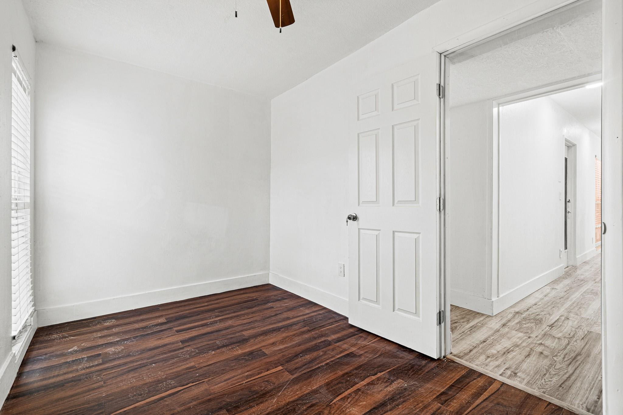 7007 Northwest 64th Street Tamarac, FL 33321 - Photo 15 of 46 a view of an empty room with wooden floor