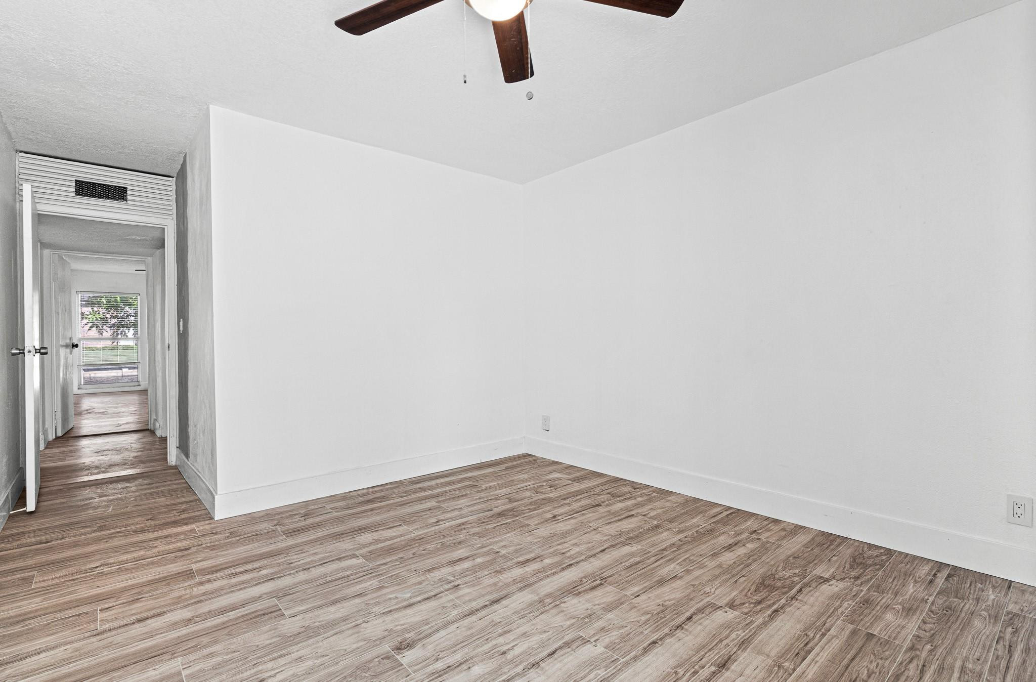 7007 Northwest 64th Street Tamarac, FL 33321 - Photo 17 of 46 wooden floor in an empty room