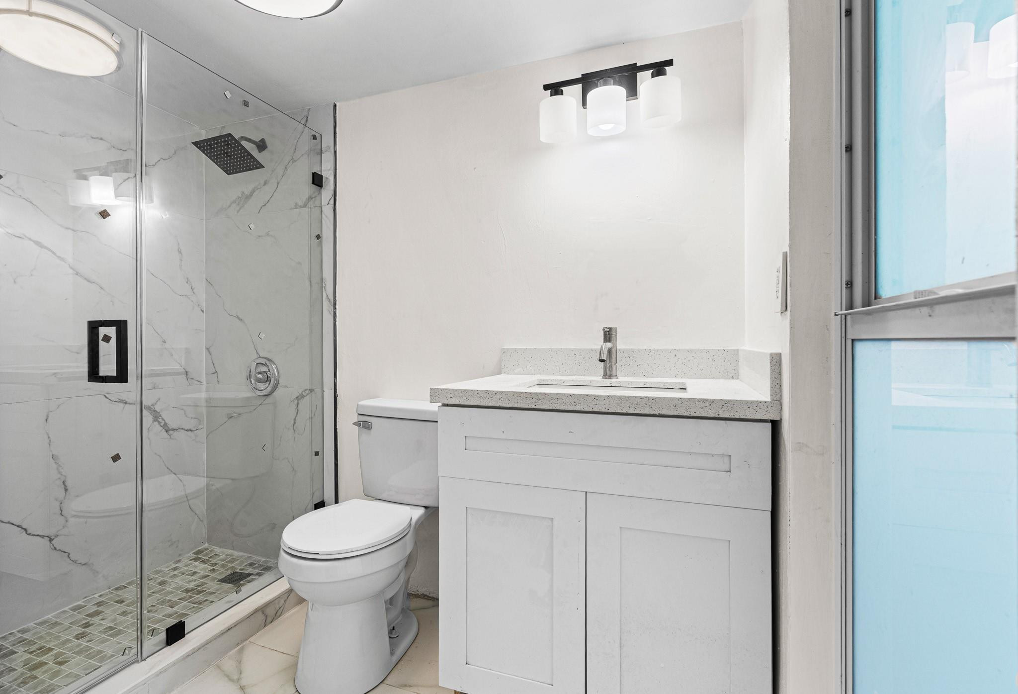 7007 Northwest 64th Street Tamarac, FL 33321 - Photo 21 of 46 a bathroom with a sink a toilet and shower