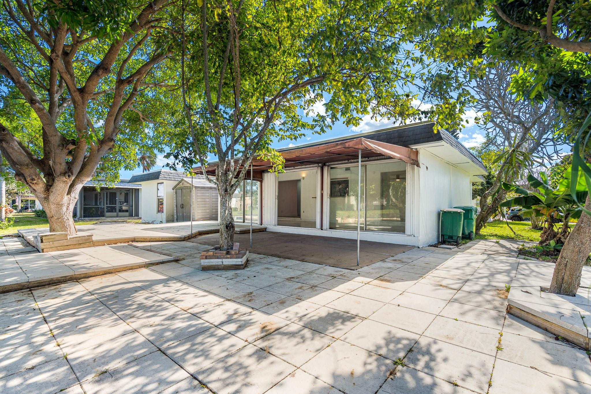 7007 Northwest 64th Street Tamarac, FL 33321 - Photo 27 of 46 a front view of a house with a yard and garage