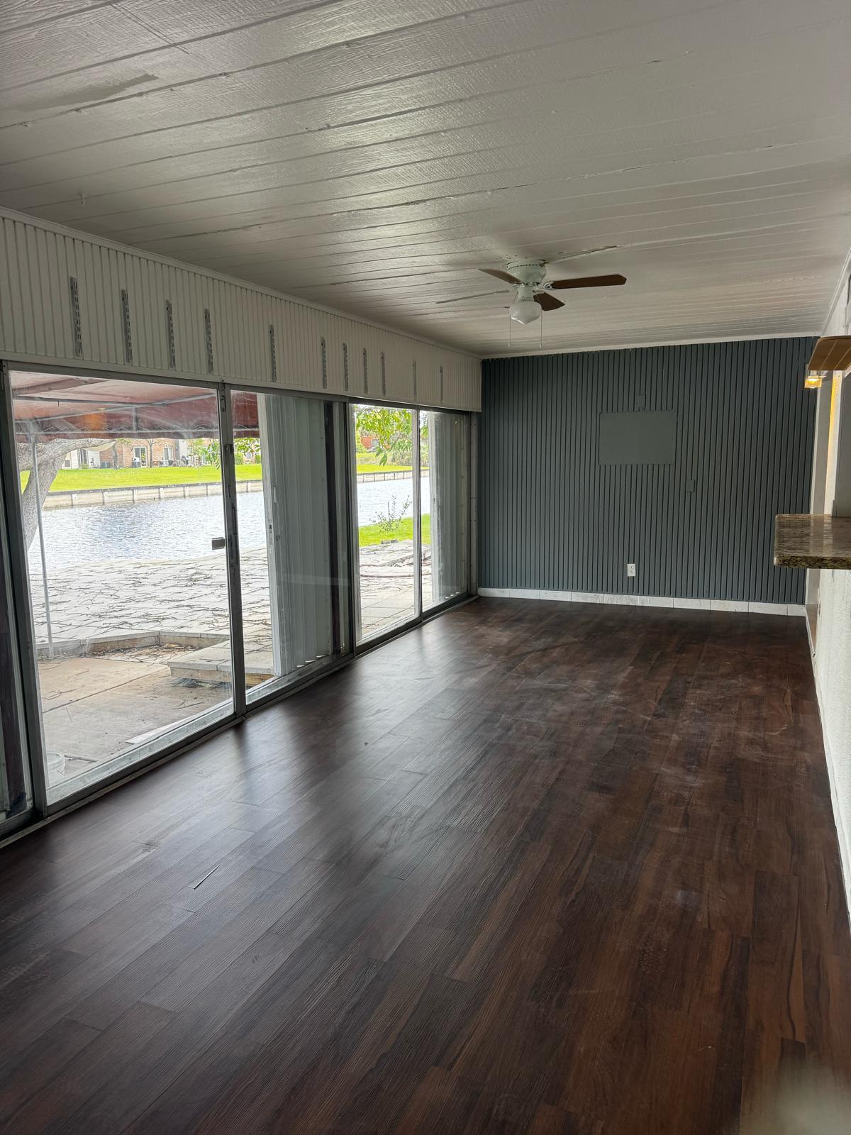 7007 Northwest 64th Street Tamarac, FL 33321 - Photo 37 of 46 an empty room with wooden floor and windows