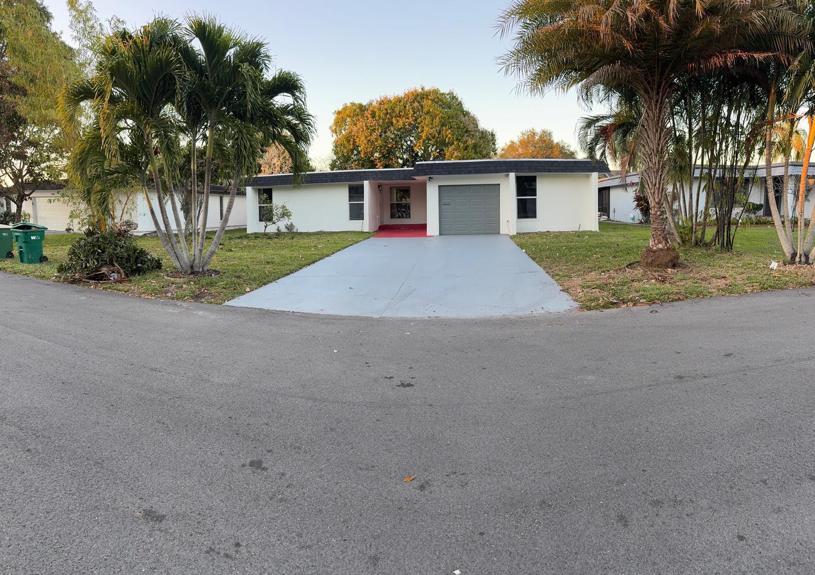 7007 Northwest 64th Street Tamarac, FL 33321 - Photo 40 of 46 front view of a house and a yard