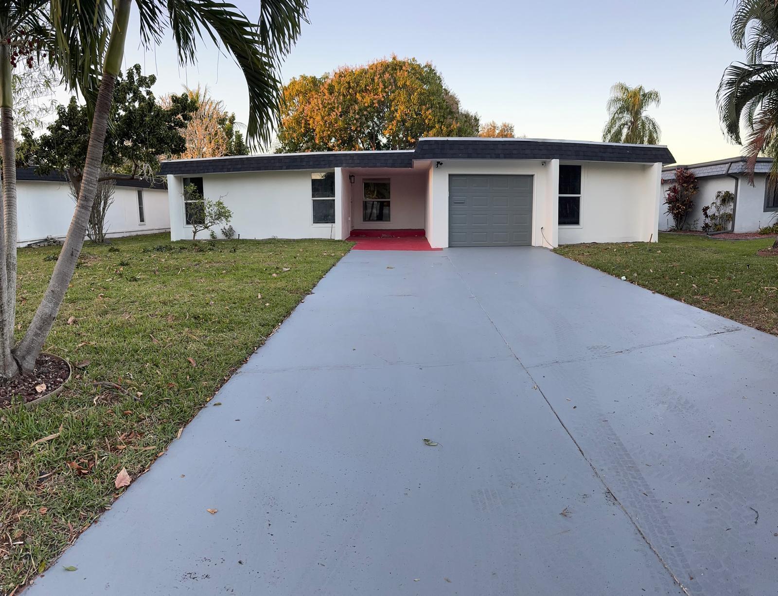 7007 Northwest 64th Street Tamarac, FL 33321 - Photo 41 of 46 a front view of house with yard and trees
