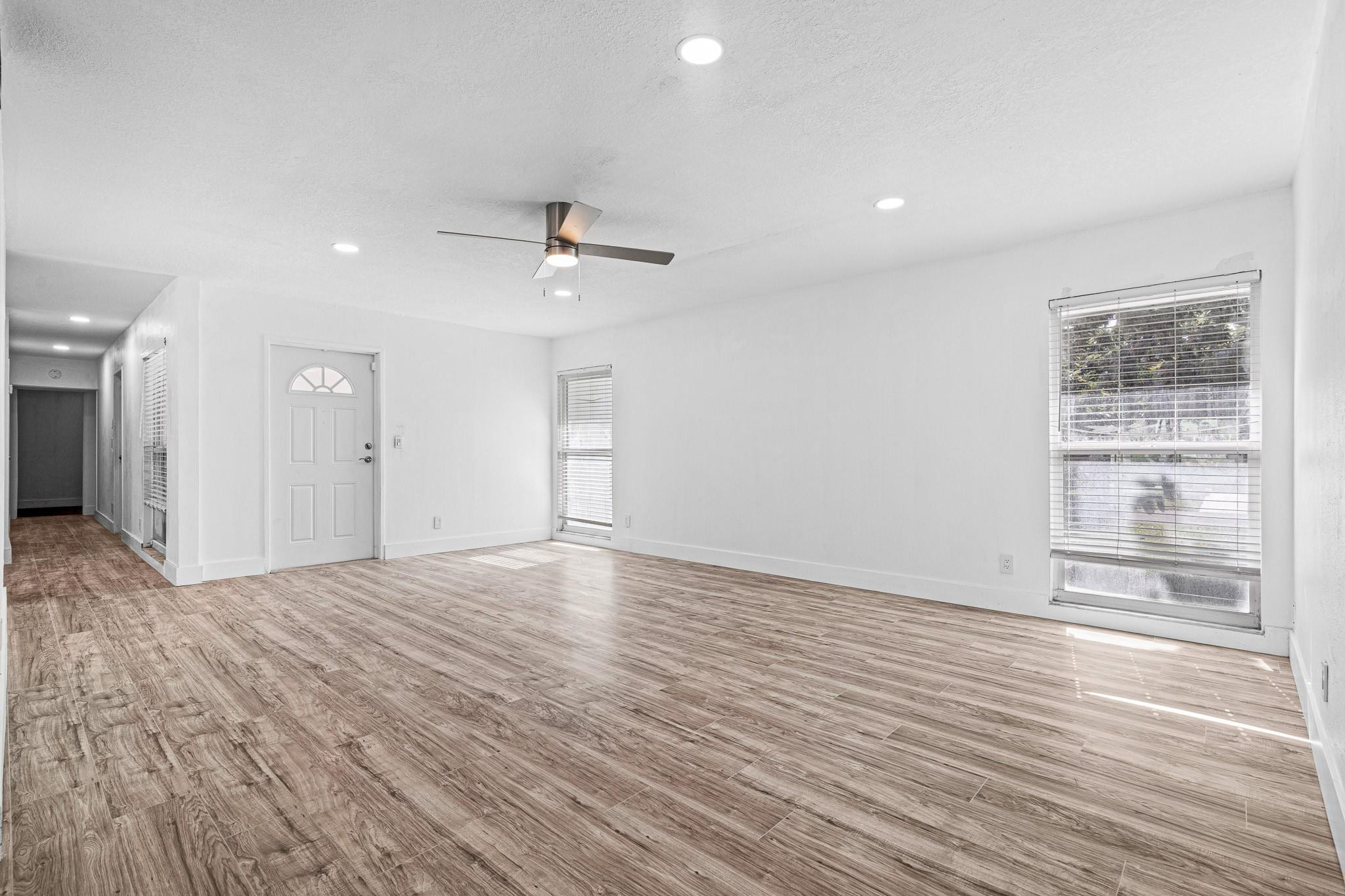 7007 Northwest 64th Street Tamarac, FL 33321 - Photo 7 of 46 a view of an empty room with a window and wooden floor
