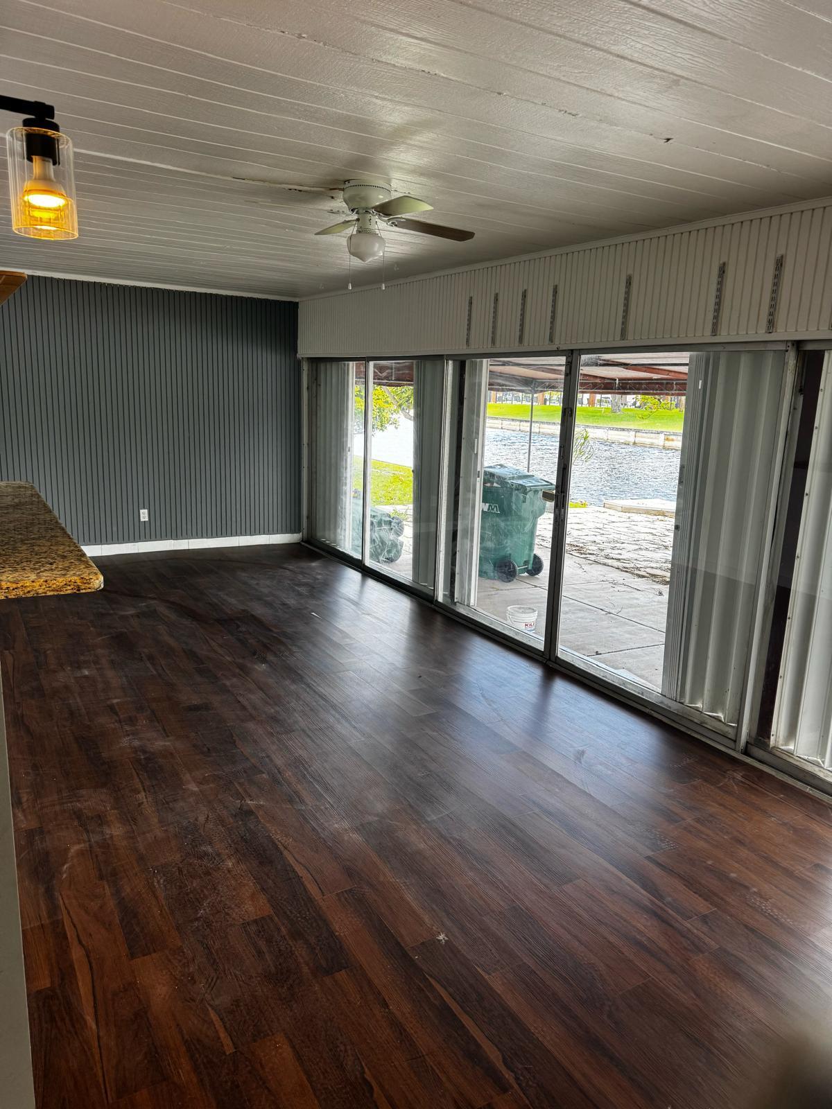 7007 Northwest 64th Street Tamarac, FL 33321 - Photo 8 of 46 an empty room with wooden floor and windows