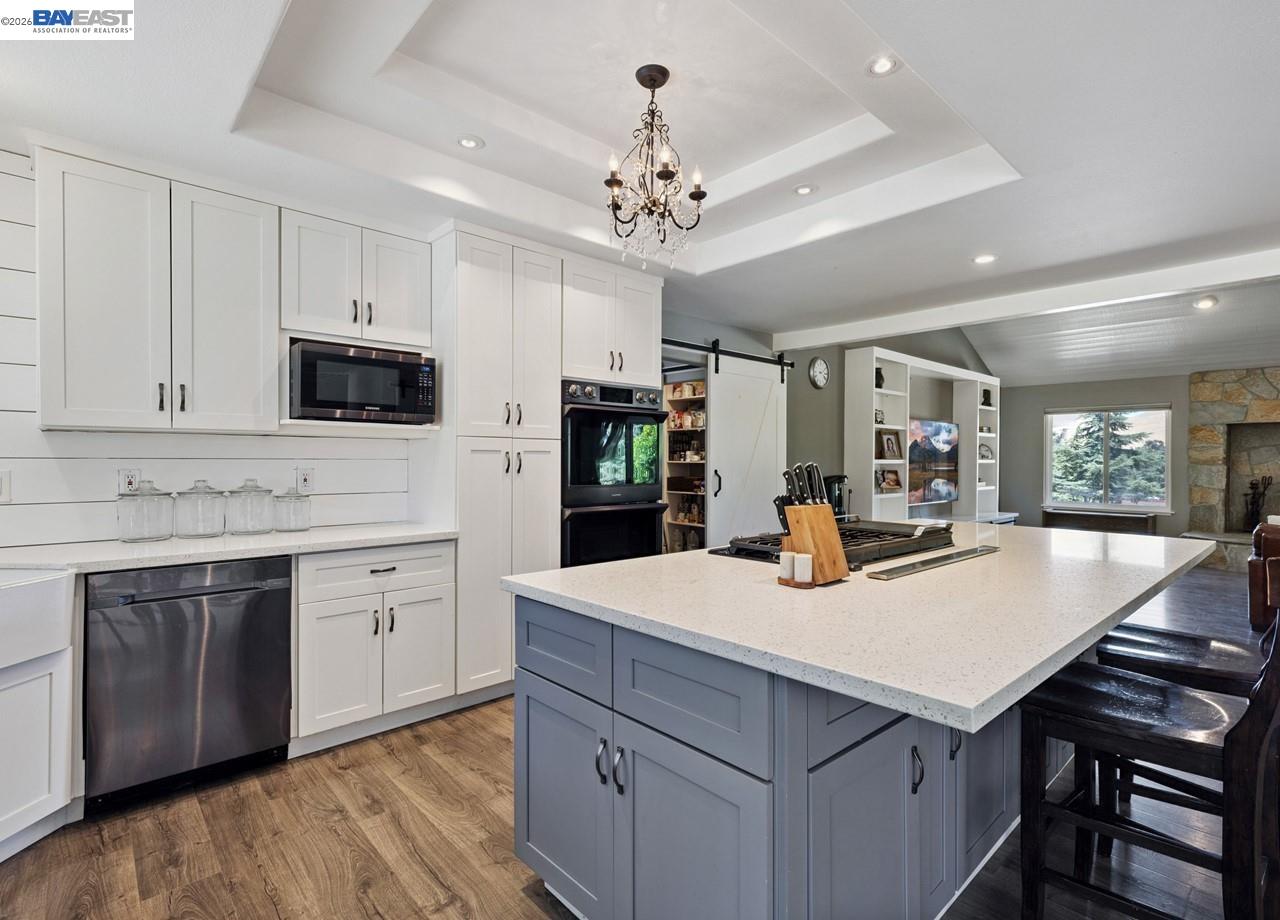 8191 Highland Road Livermore, CA 94551 - Photo 16 of 59 a kitchen with a stove a sink dishwasher a refrigerator with white cabinets and wooden floor