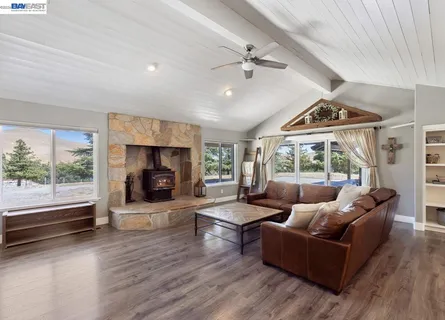 a living room with furniture a flat screen tv and a table