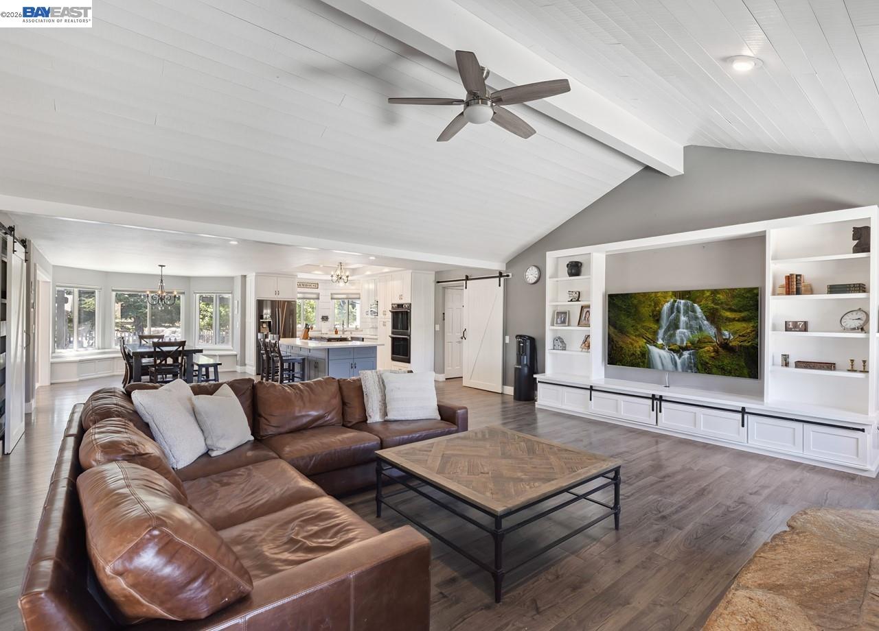 8191 Highland Road Livermore, CA 94551 - Photo 20 of 59 a living room with furniture a flat screen tv and a table