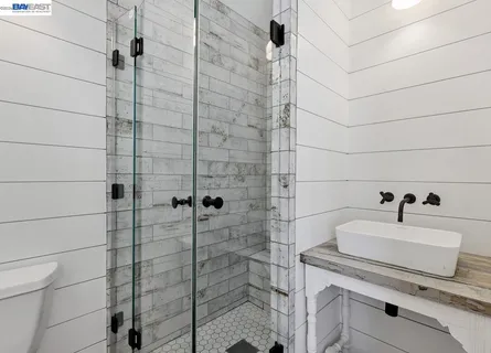 a bathroom with double vanity and a mirror