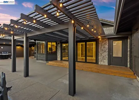 a view of a swimming pool with a patio and a yard