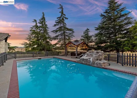 a view of a swimming pool with a patio