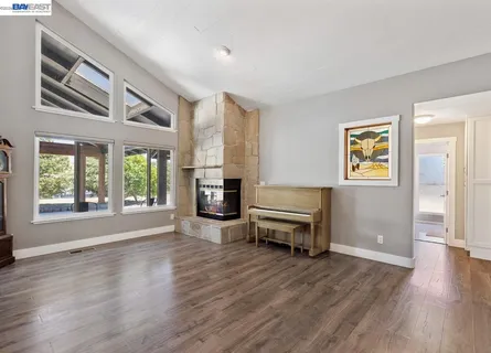 a big room with wooden floor and balcony