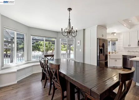 a view of a dining room with furniture window and wooden floor