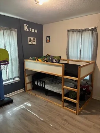 a bedroom with a bed and a desk