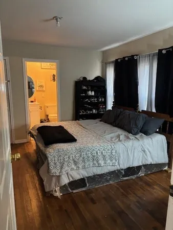 a bedroom with a bed and window