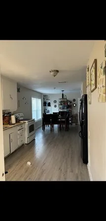 a living room with furniture and a dining table