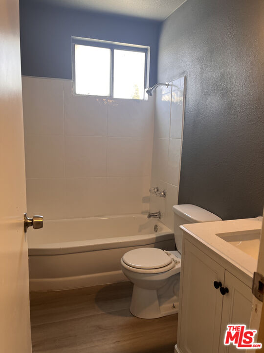 602 North Sloan Avenue, Unit A Compton, CA 90221 - Photo 4 of 9 a white toilet sitting next to a bathroom sink and a tub