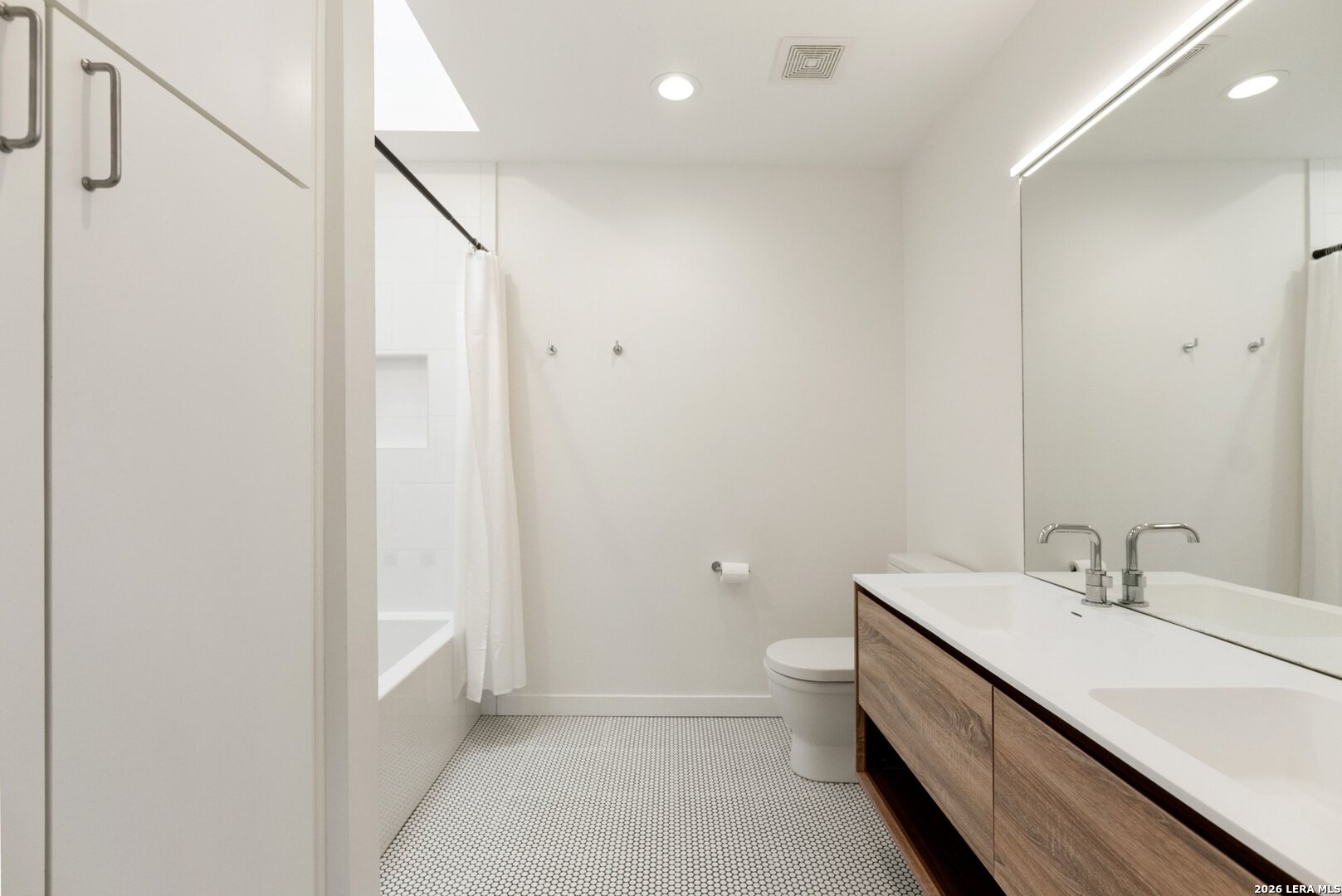 1402 Hutto Road Georgetown, TX 78626 - Photo 20 of 34 a bathroom with a double vanity sink and mirror