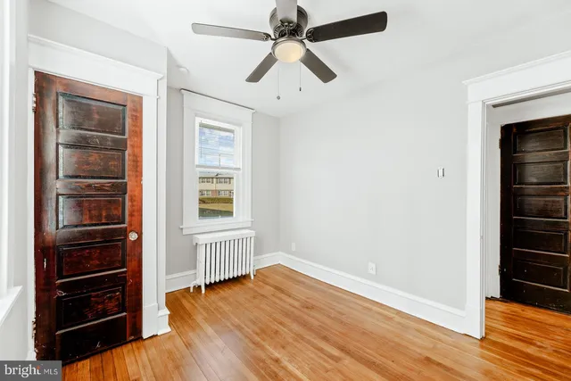 wooden floor in an empty room with a window