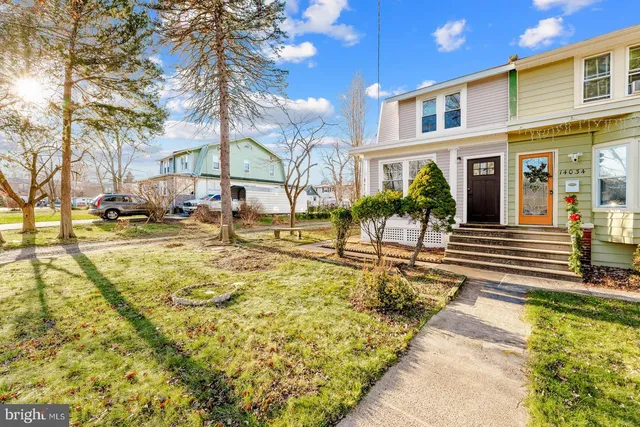 a view of a house with pool and sitting area