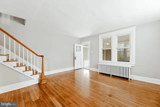 wooden floor in an empty room with a window