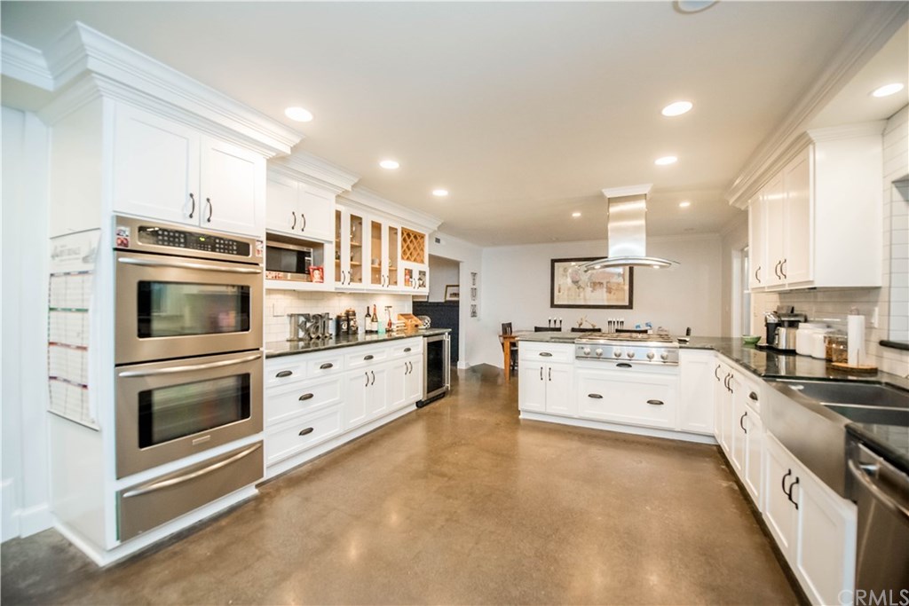 2841 Europa Drive Costa Mesa, CA 92626 - Photo 13 of 30 a kitchen with stainless steel appliances and white cabinets