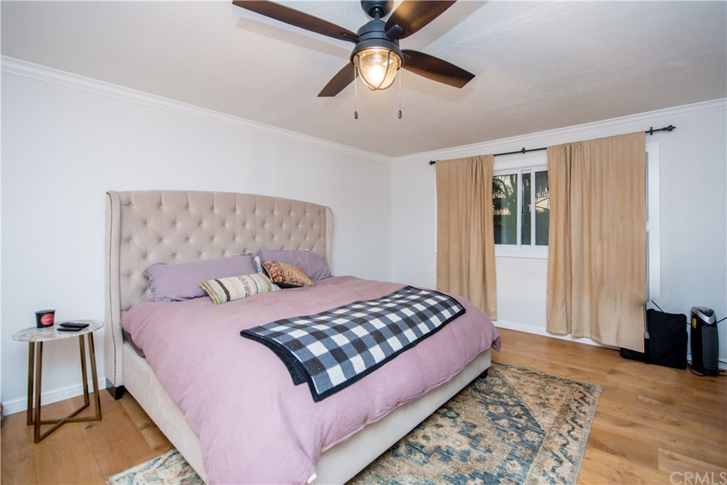 2841 Europa Drive Costa Mesa, CA 92626 - Photo 20 of 30 a bedroom with a bed chandelier and a window