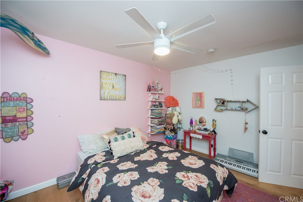 2841 Europa Drive Costa Mesa, CA 92626 - Photo 23 of 30 a bedroom with a bed and a chandelier