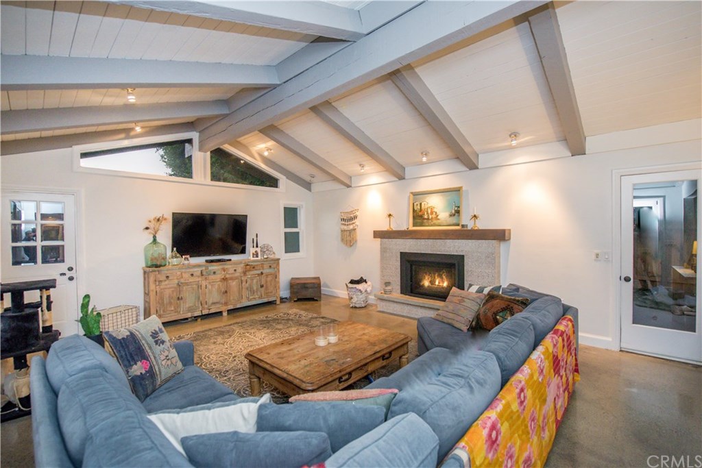 2841 Europa Drive Costa Mesa, CA 92626 - Photo 6 of 30 a living room with furniture a flat screen tv and a fireplace