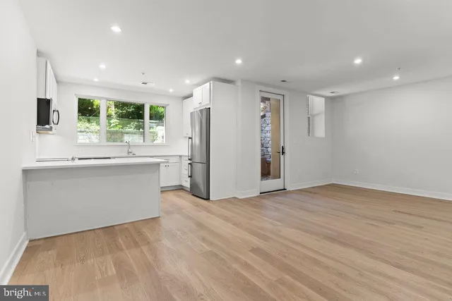 a view of kitchen with refrigerator and window
