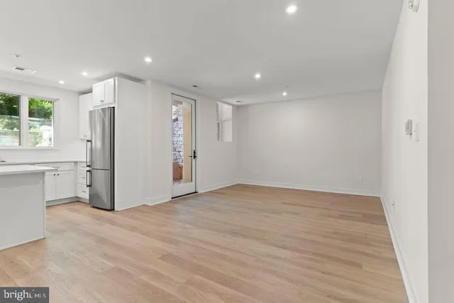 a view of a kitchen with a refrigerator and a sink