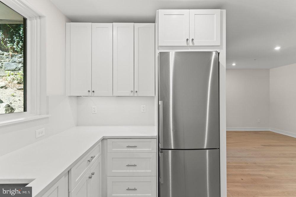 3016 Dumbarton Street Northwest, Unit 102 Washington, DC 20007 - Photo 20 of 23 a kitchen with cabinets and a refrigerator