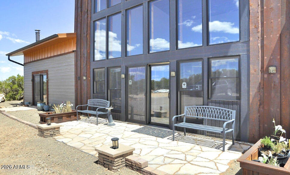 12 County Road Snowflake, AZ 85937 - Photo 35 of 85 a view of a chair and tables in the patio with a backyard