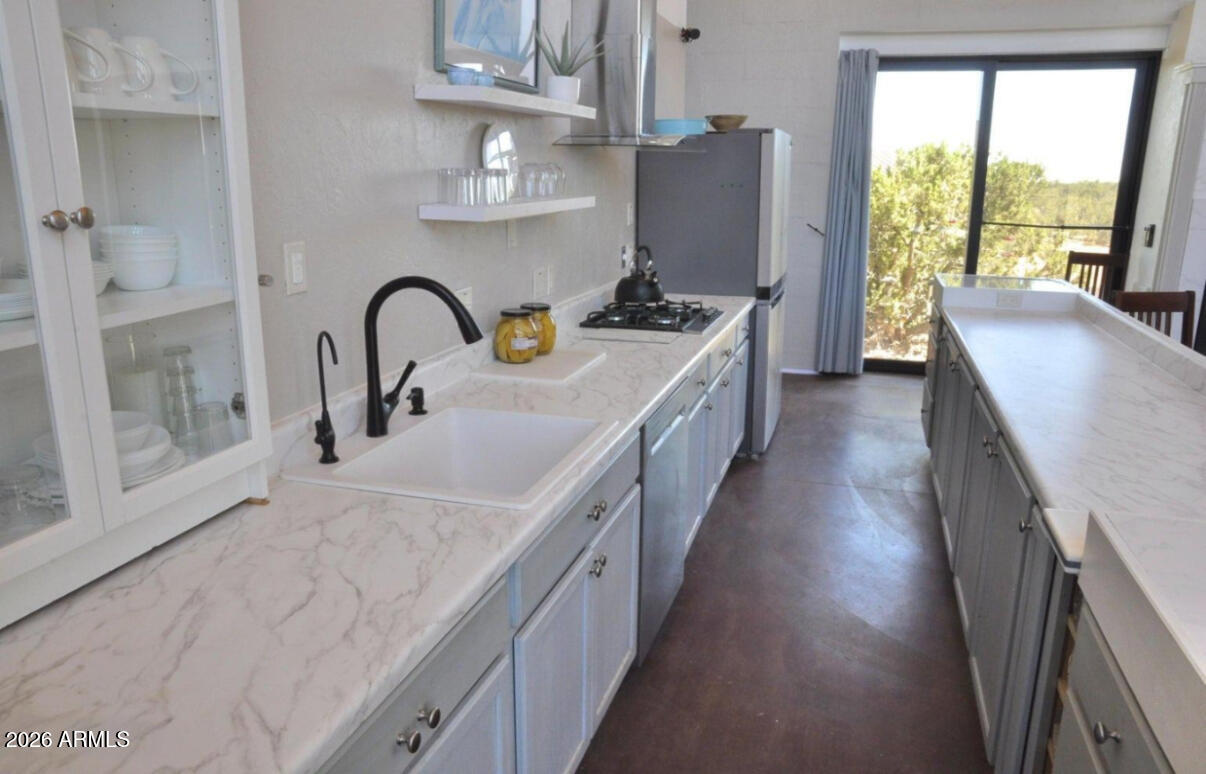 12 County Road Snowflake, AZ 85937 - Photo 9 of 85 a kitchen with stainless steel appliances granite countertop sink stove and refrigerator