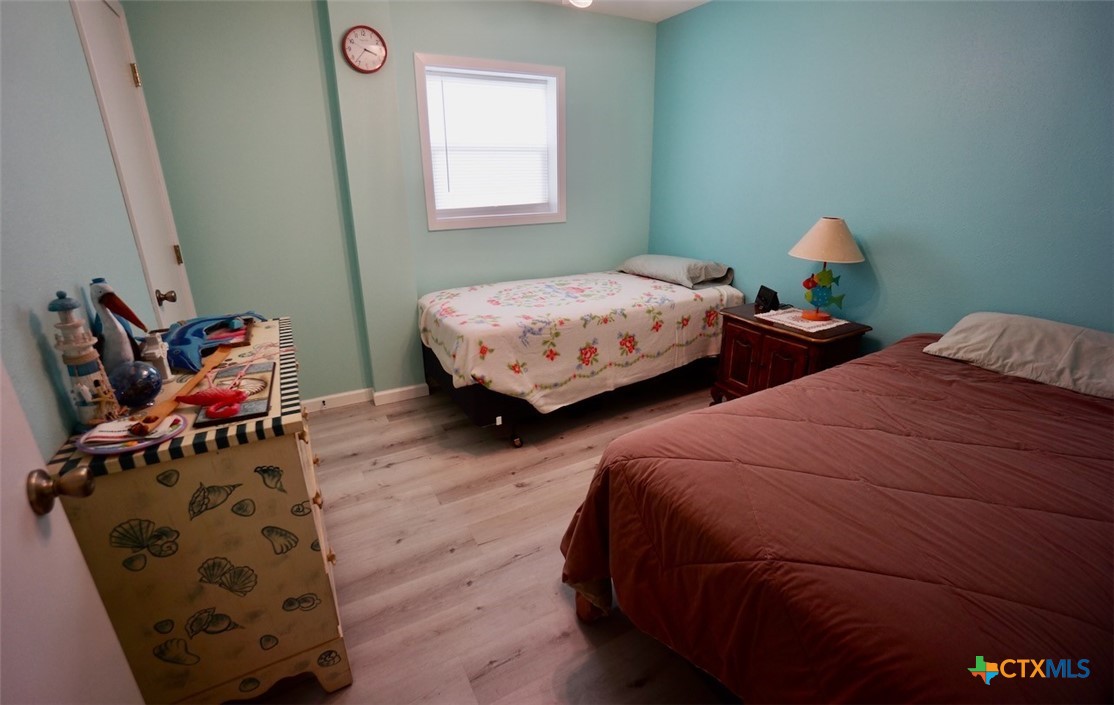 811 Main Street Port O'Connor, TX 77982 - Photo 25 of 36 a bedroom with two beds and a window