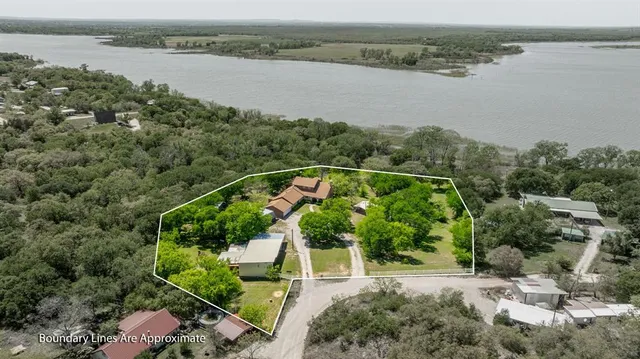 an aerial view of a house with a lake view