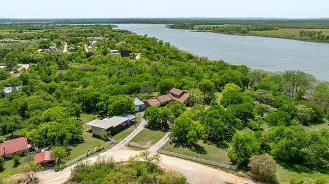 an aerial view of a house with a lake view