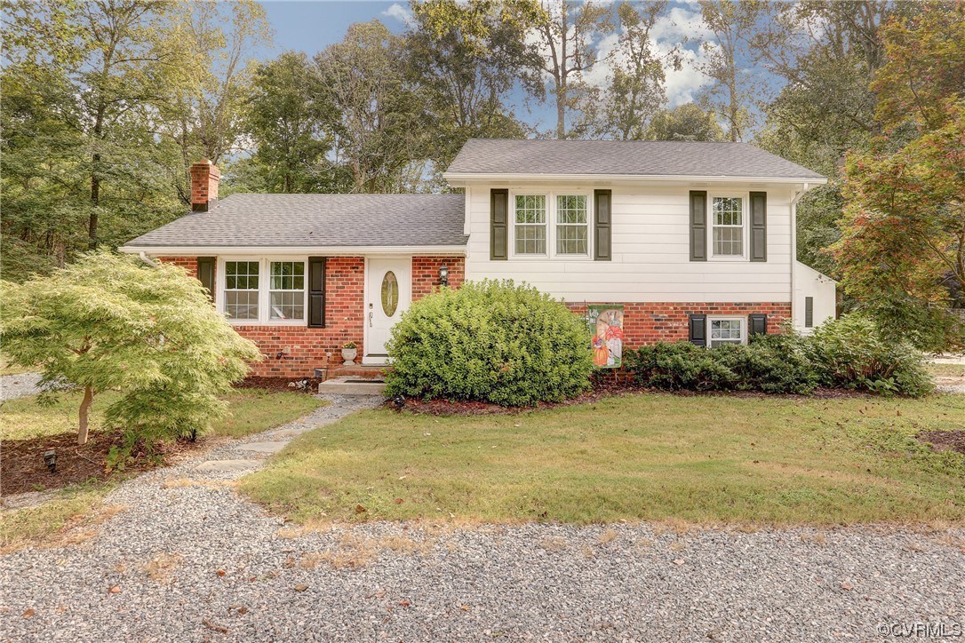 6723 Cherry Road Quinton, VA 23141 - Photo 1 of 44 a front view of a house with garden