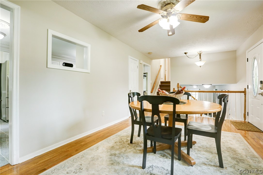 6723 Cherry Road Quinton, VA 23141 - Photo 13 of 44 a view of a dining room with furniture and a chandelier fan