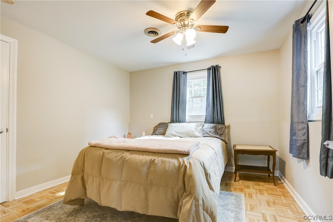 6723 Cherry Road Quinton, VA 23141 - Photo 16 of 44 a bedroom with a bed and a chandelier