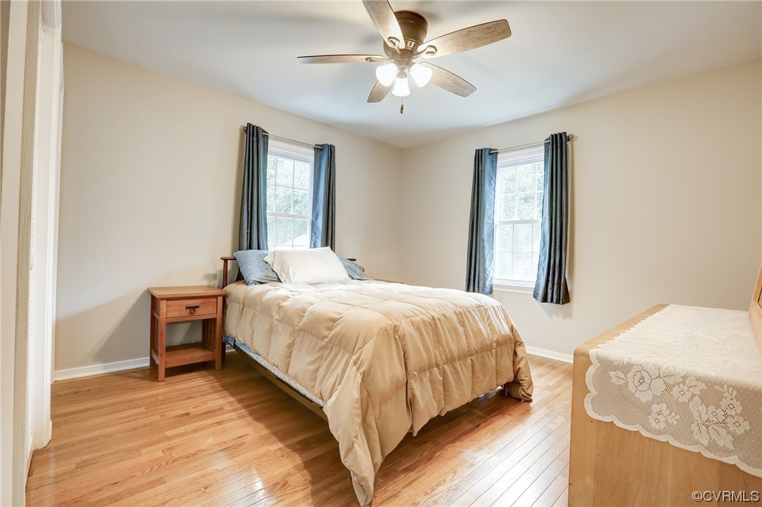 6723 Cherry Road Quinton, VA 23141 - Photo 19 of 44 a bedroom with a large bed and a chandelier