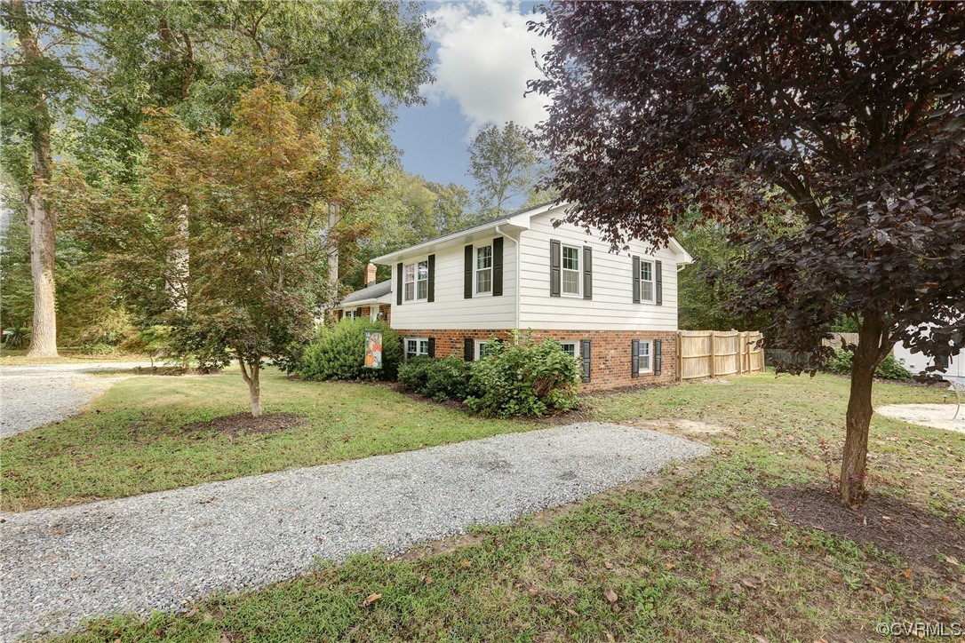 6723 Cherry Road Quinton, VA 23141 - Photo 2 of 44 a front view of a house with a yard and trees