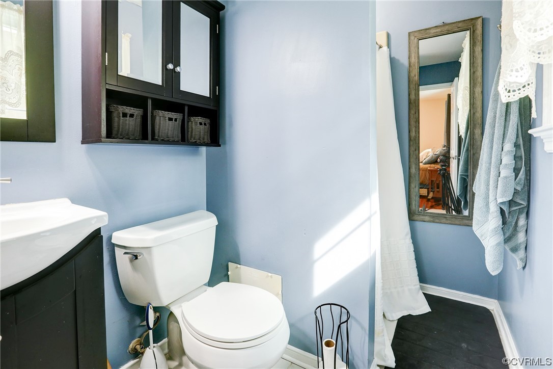 6723 Cherry Road Quinton, VA 23141 - Photo 22 of 44 a white toilet sitting next to a bathroom sink