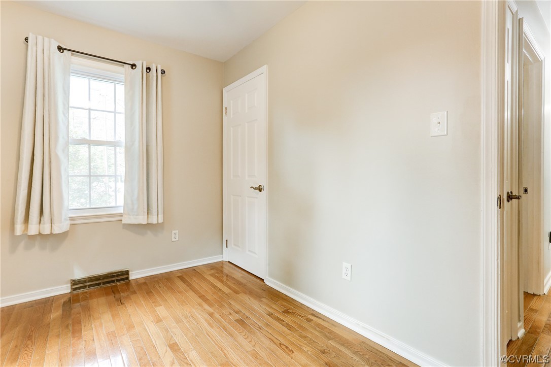 6723 Cherry Road Quinton, VA 23141 - Photo 23 of 44 a view of an empty room with wooden floor and a window