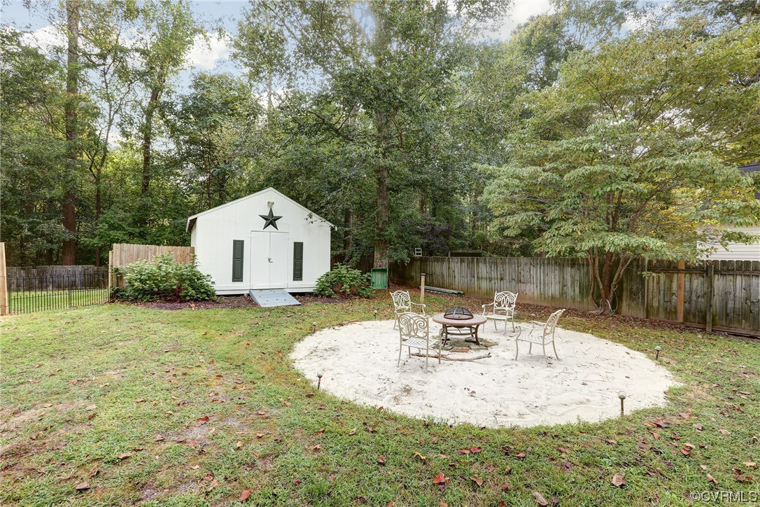 6723 Cherry Road Quinton, VA 23141 - Photo 30 of 44 a view of backyard with table and chairs and wooden fence