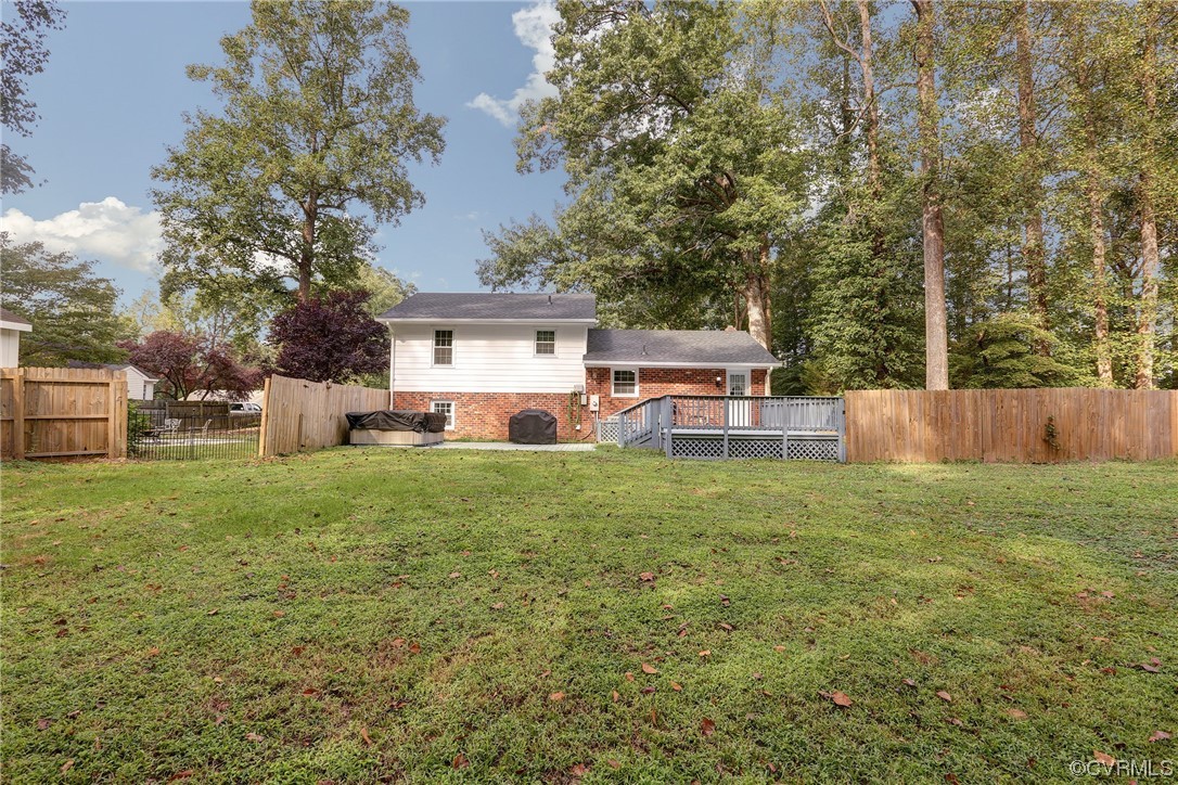 6723 Cherry Road Quinton, VA 23141 - Photo 32 of 44 a view of a backyard with table and chairs potted plants and large tree