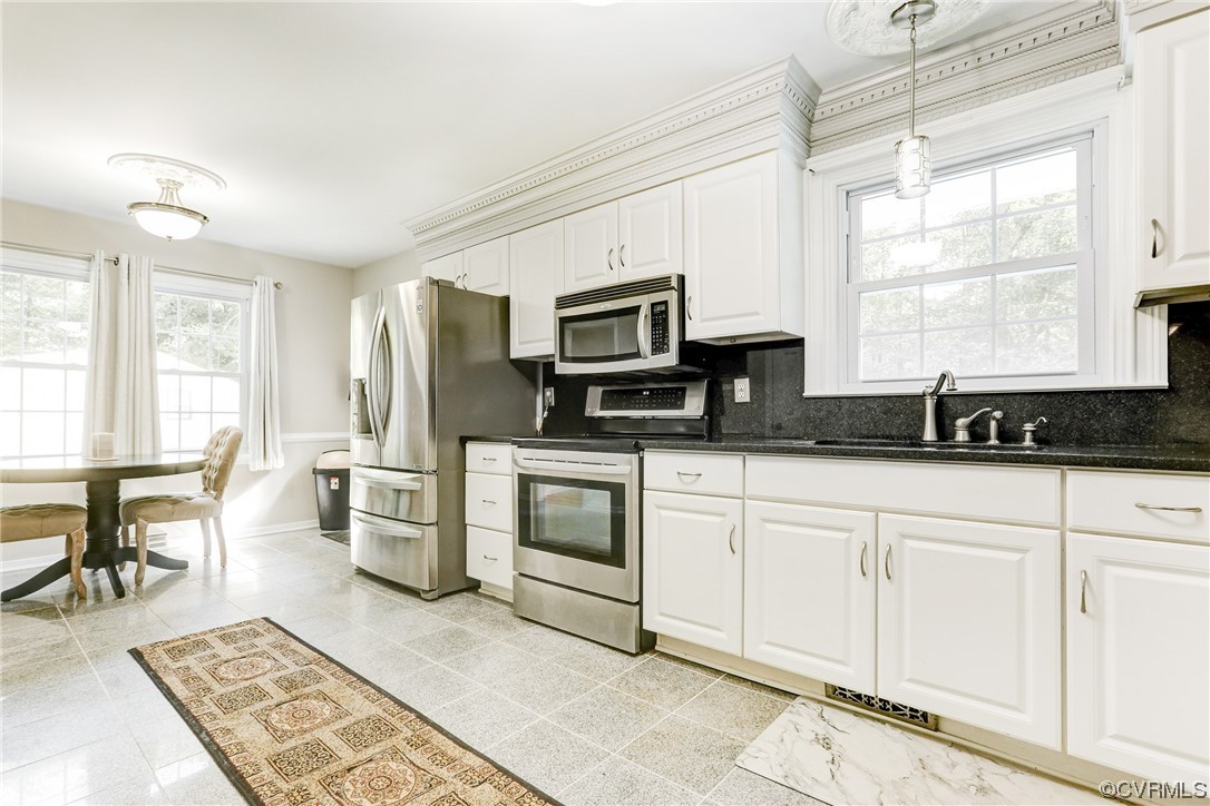 6723 Cherry Road Quinton, VA 23141 - Photo 7 of 44 a kitchen with granite countertop a stove a sink and a microwave